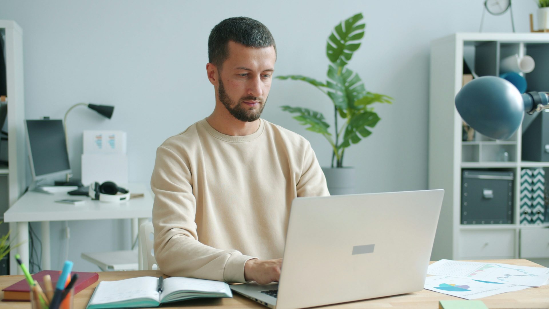 Man working on a laptop at a desk.